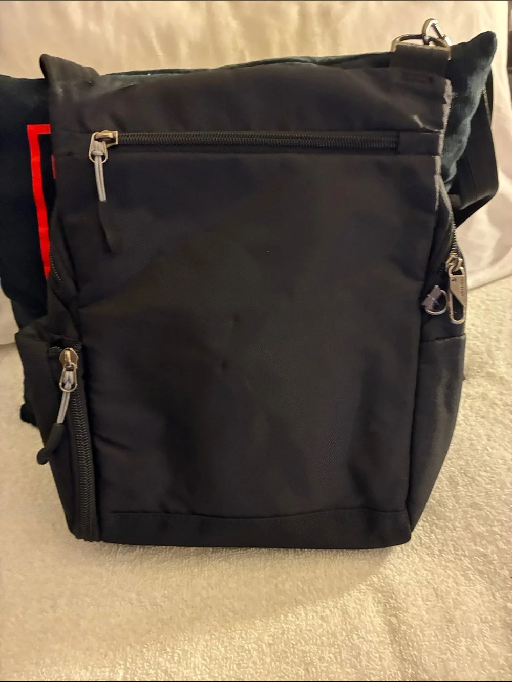 Travelon Black Sling Backpack with Red Accent